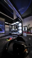 A gaming room with a large monitor and a mouse