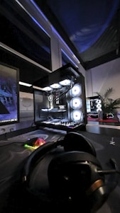 A gaming room with a large monitor and a mouse