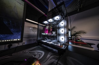 A room with a computer monitor and a keyboard