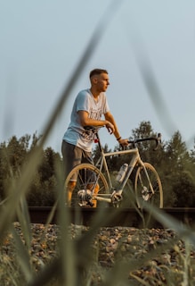 A man riding a bike down a train track