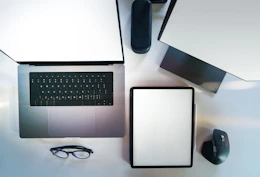 A laptop computer sitting on top of a white desk