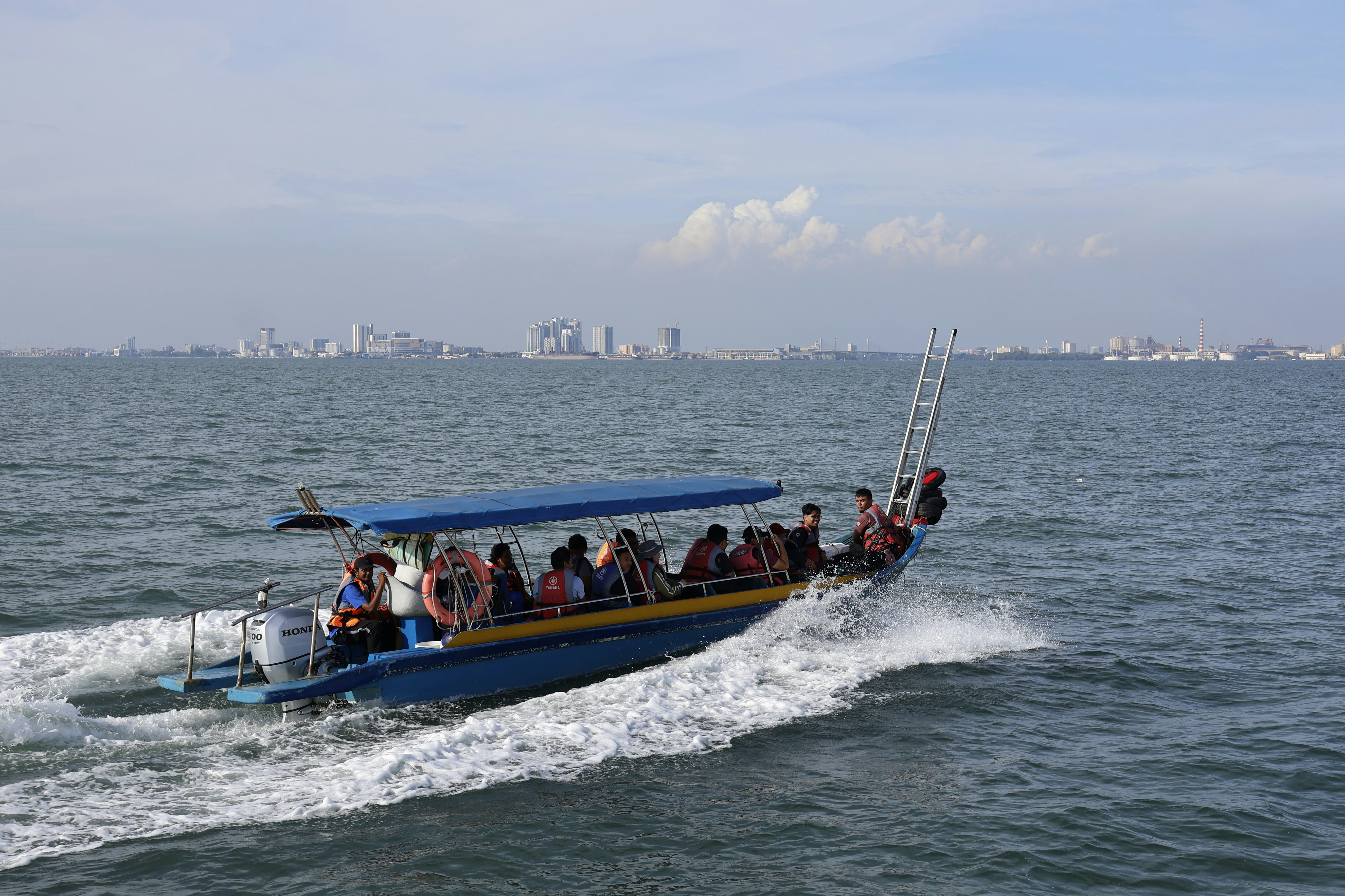 A group of people riding on the back of a boat photo – Free Penang ...