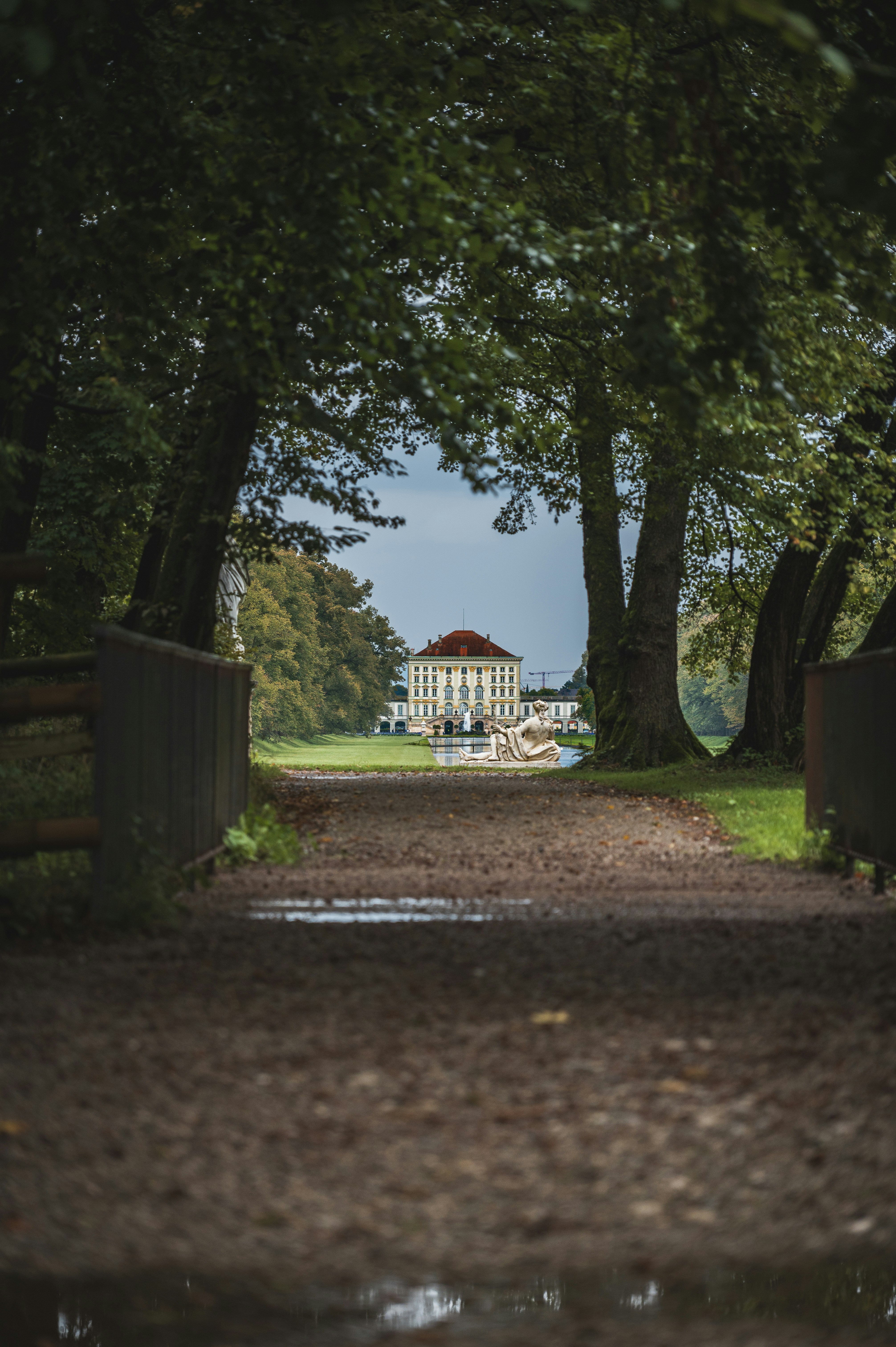 A path leading to a large white building in the distance