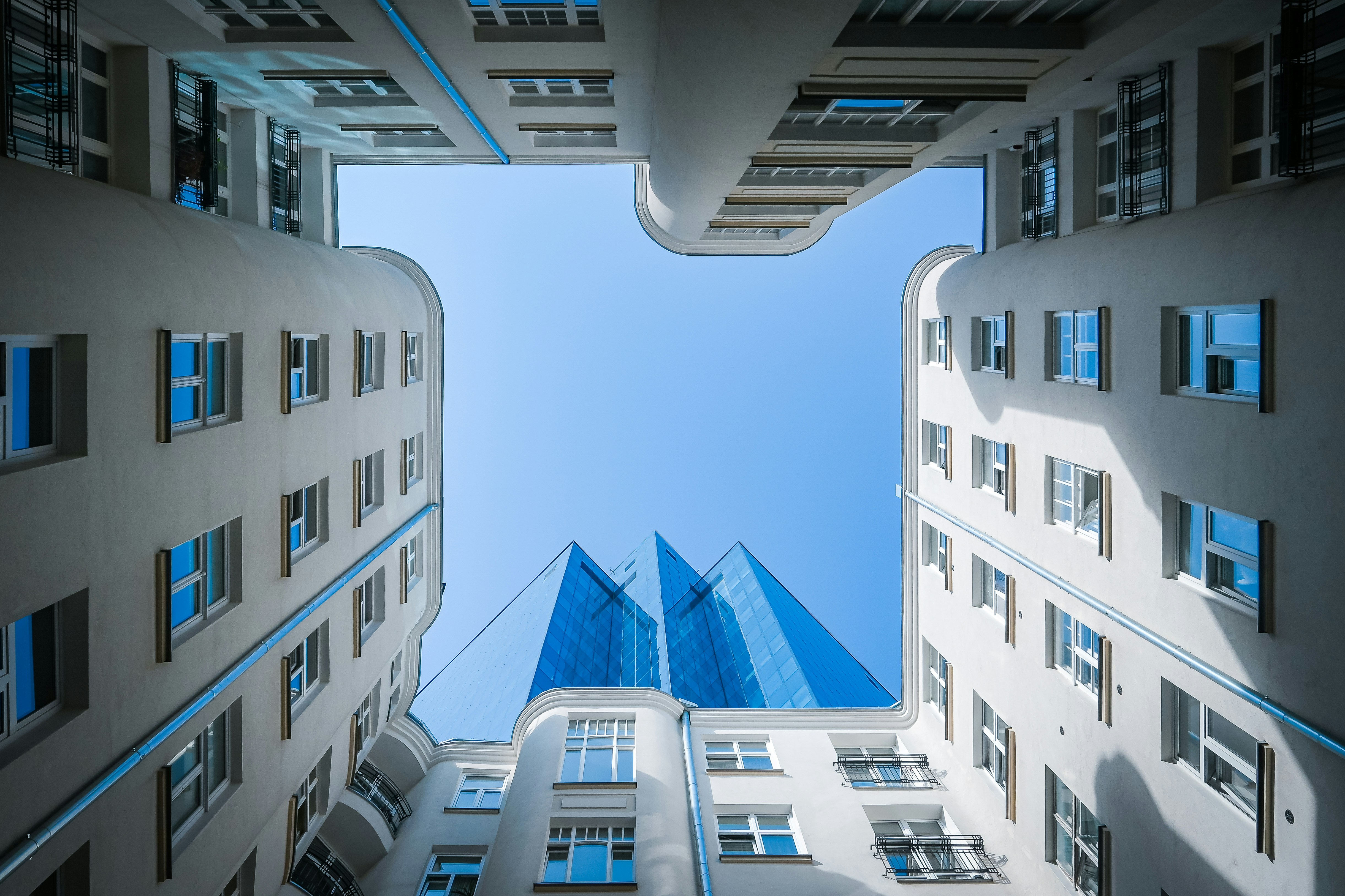 Looking up at tall buildings from the ground