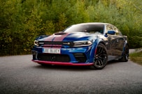 A blue car parked on the side of a road