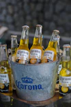 A bucket full of corona beer sitting on a table