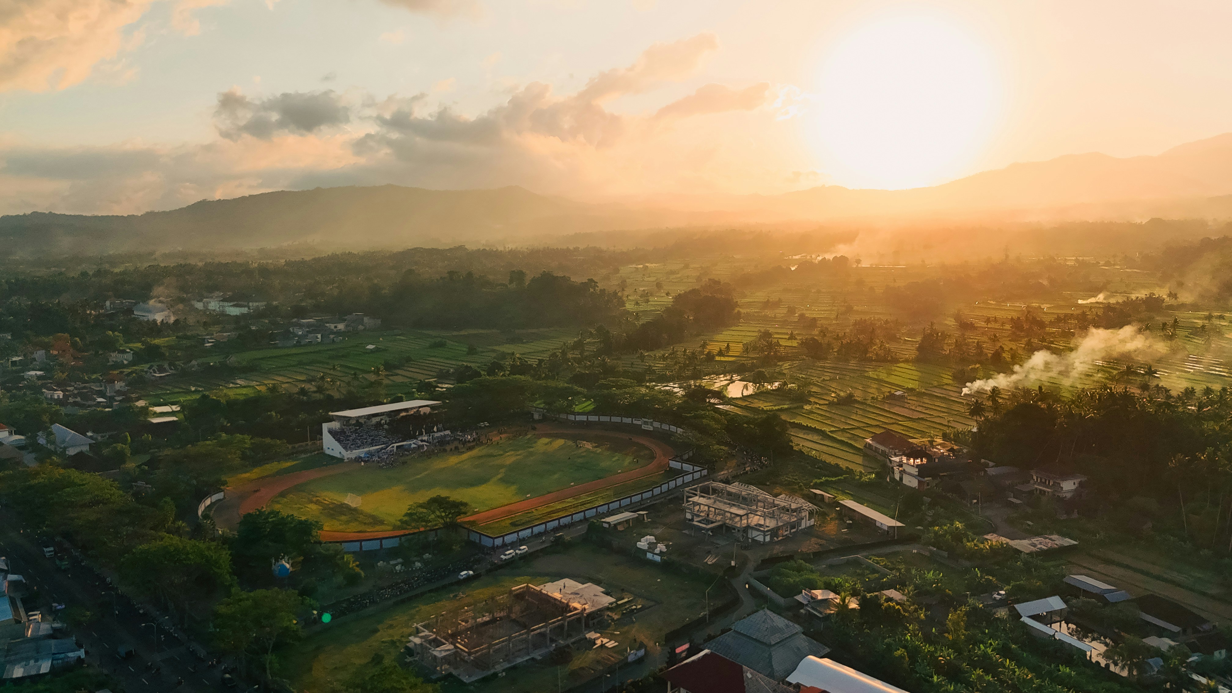 An aerial view of a baseball field at sunset