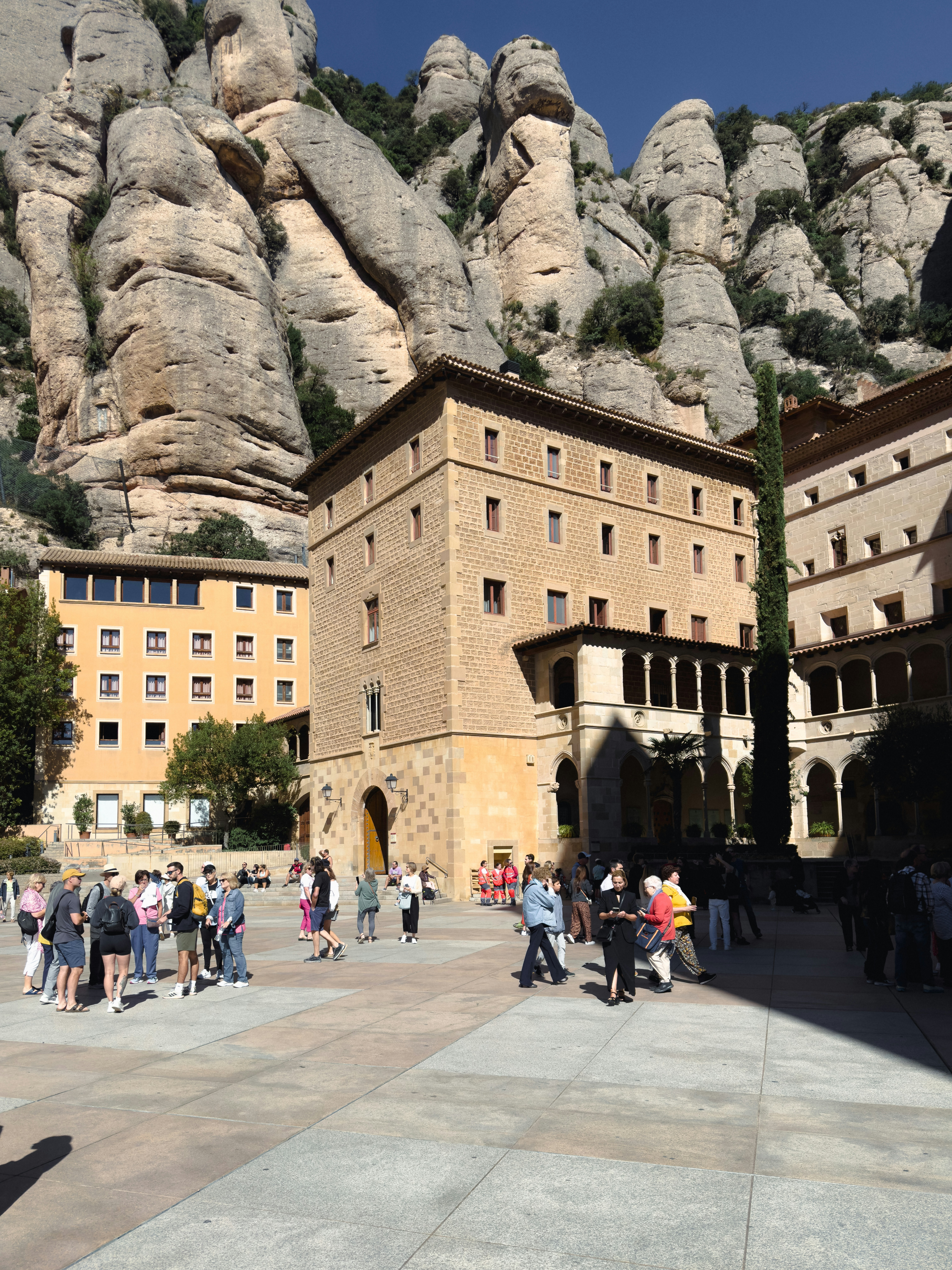 A group of people standing in front of a mountain