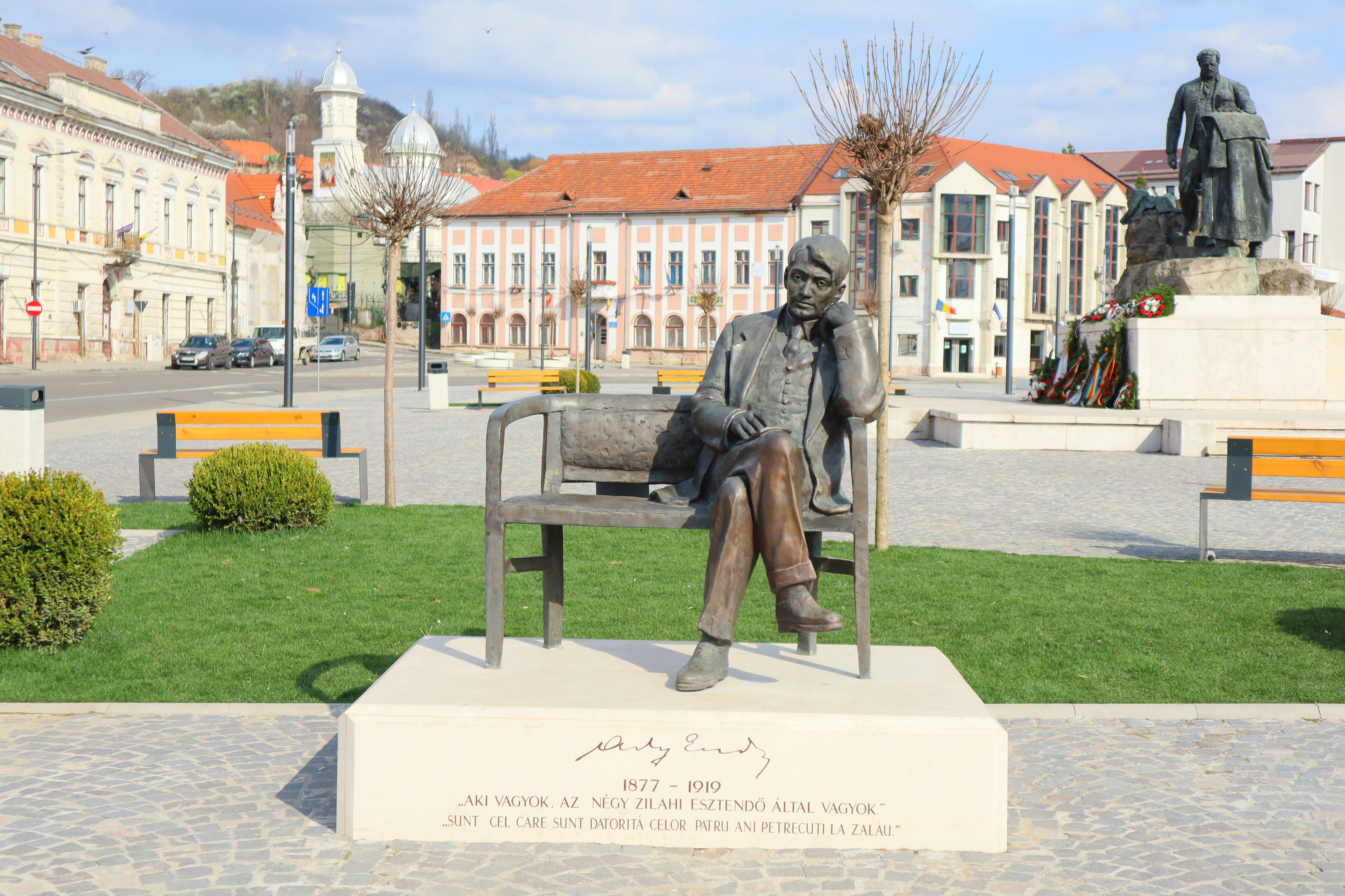 A statue of a man sitting on a bench