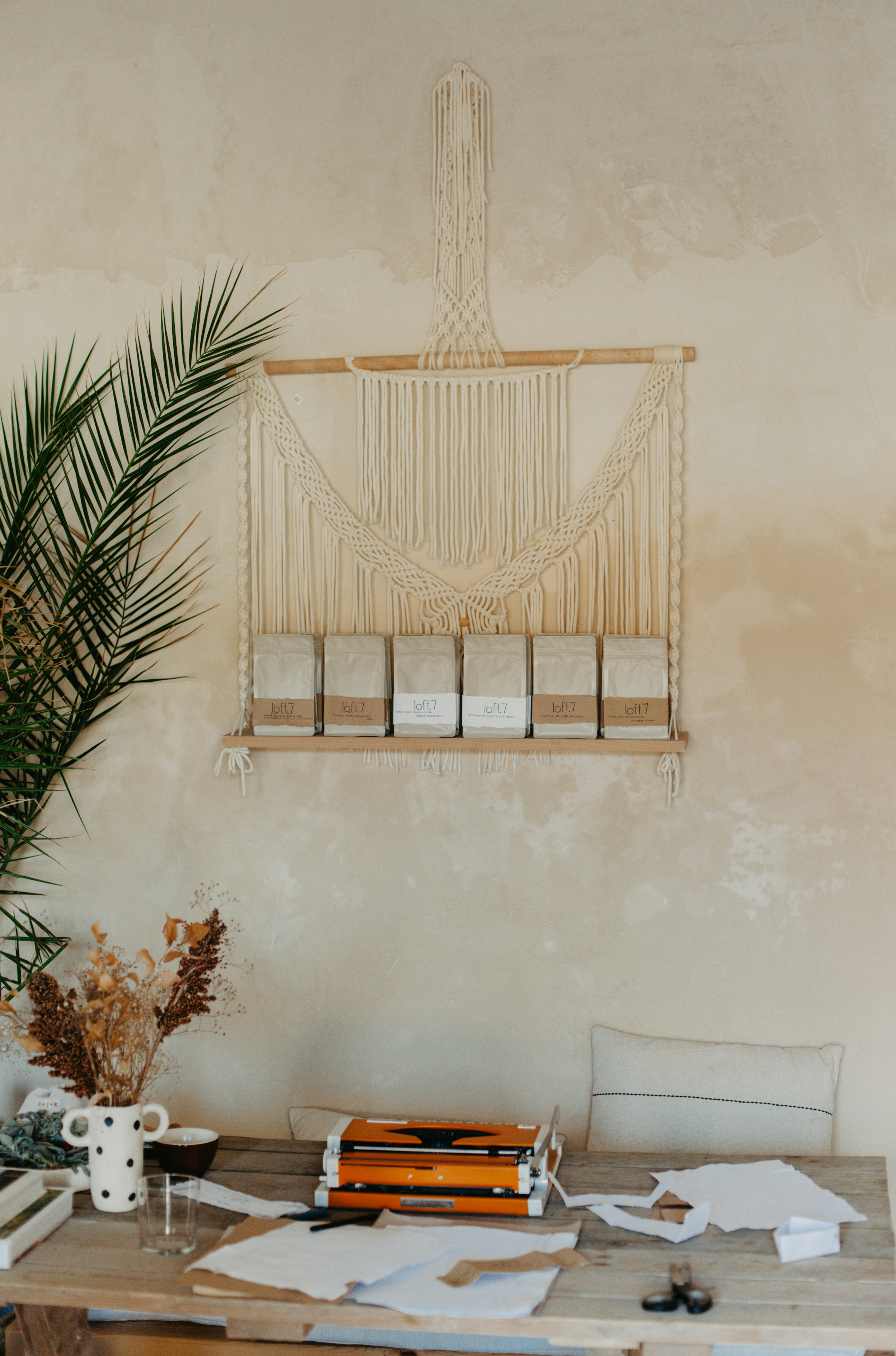 A wooden table topped with books and a plant
