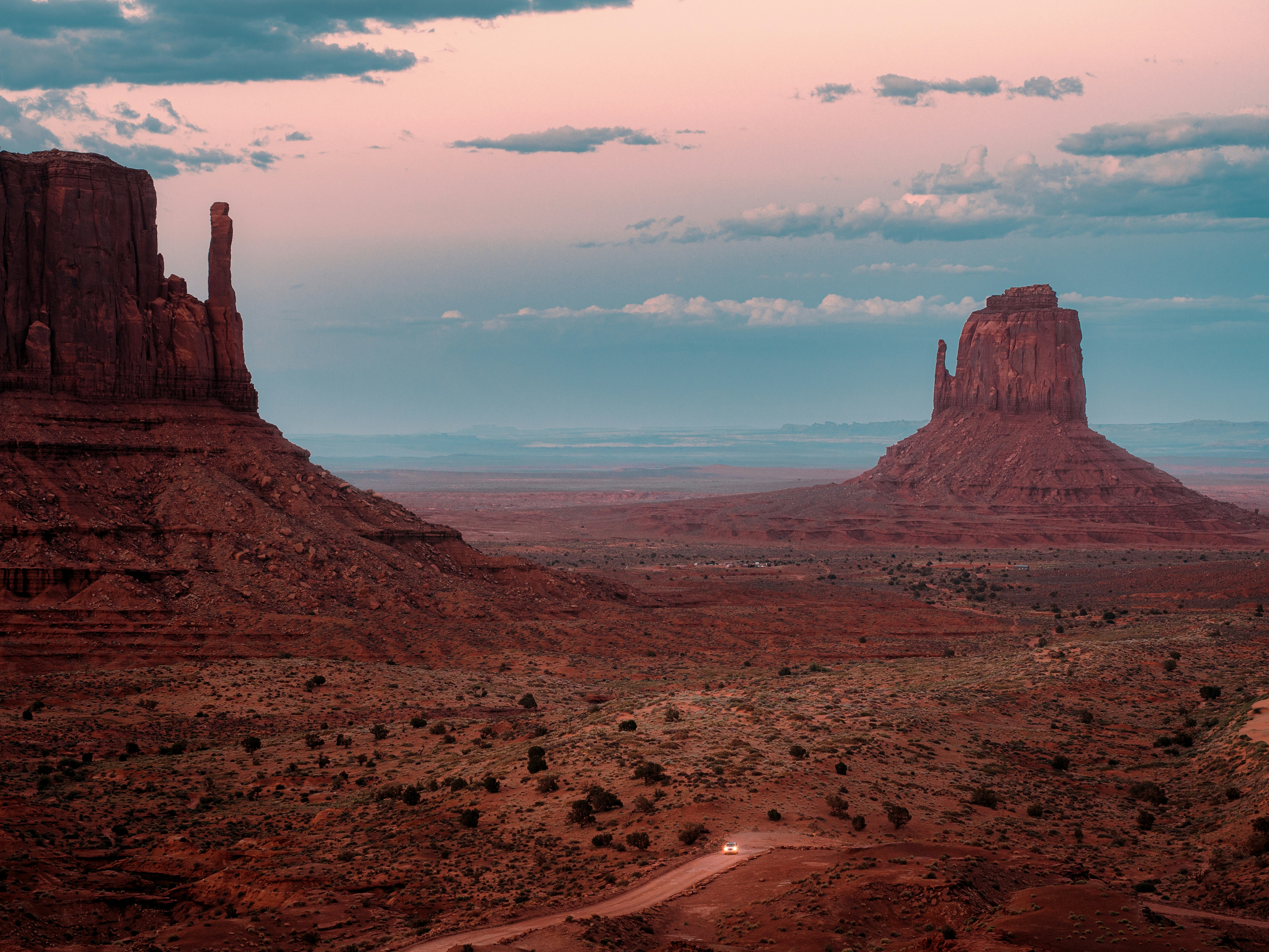 A view of a desert with a mountain in the background