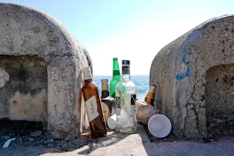 A group of bottles sitting on top of a cement wall