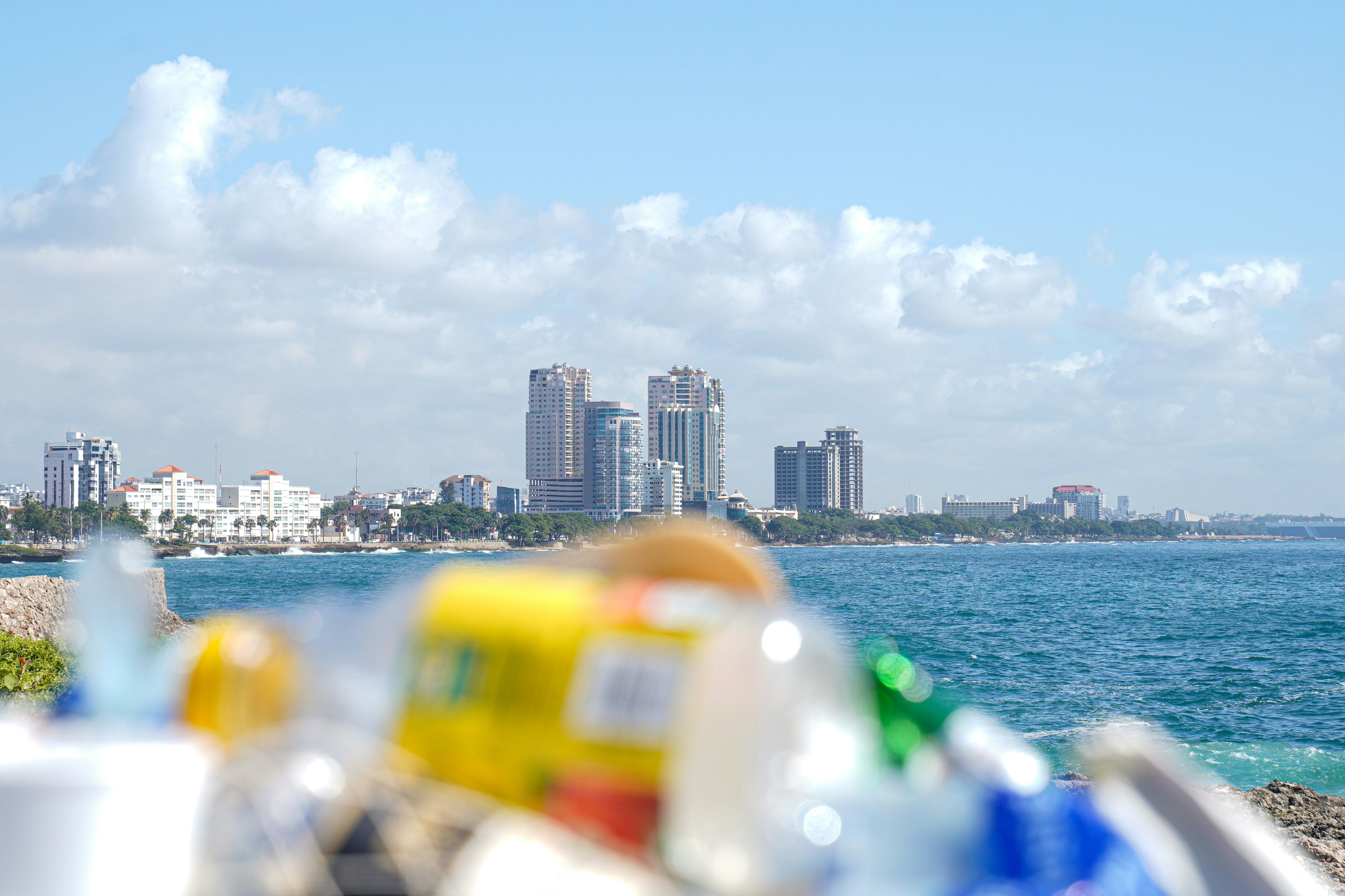 A row of trash cans sitting on top of a beach