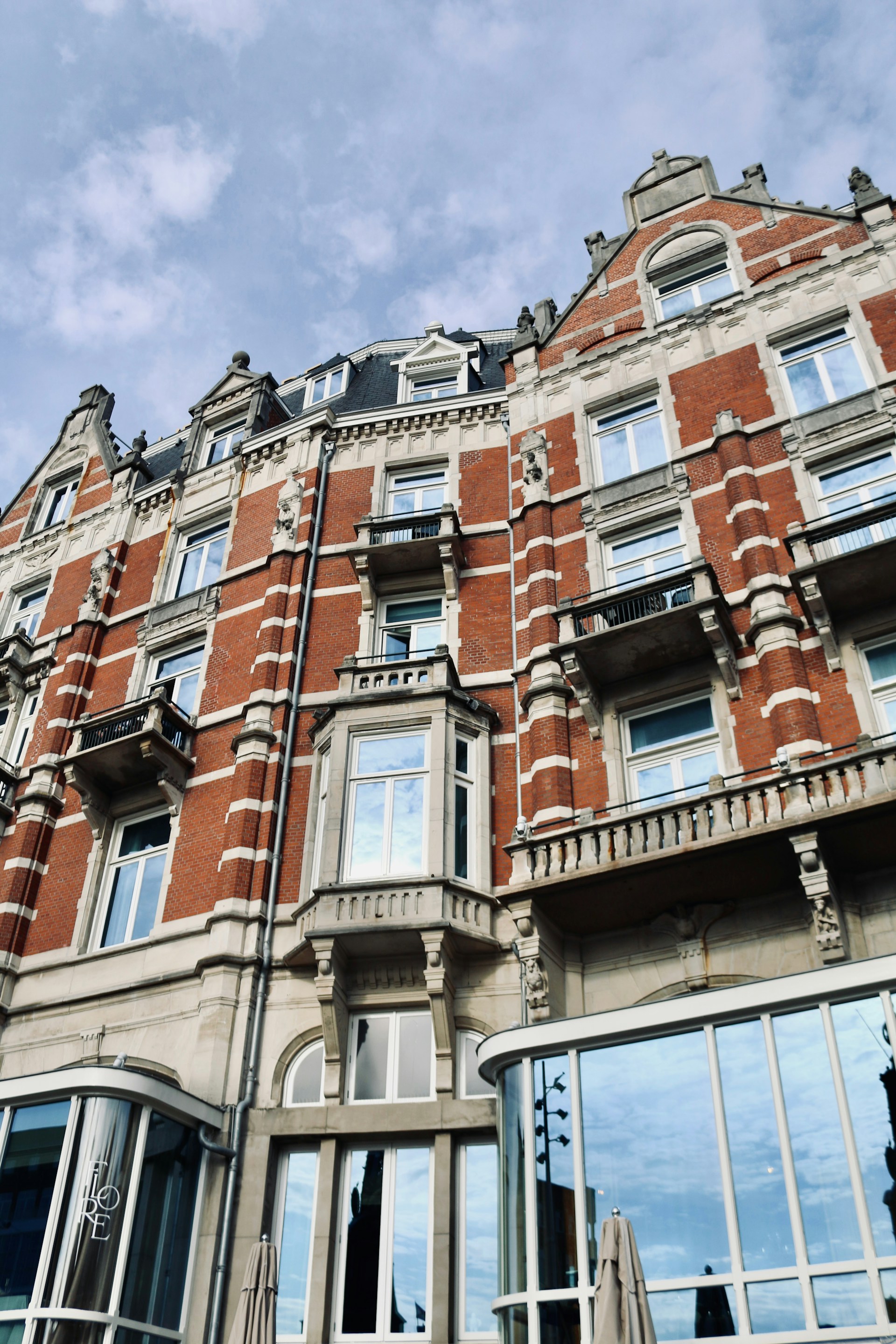 A tall building with lots of windows and a sky background