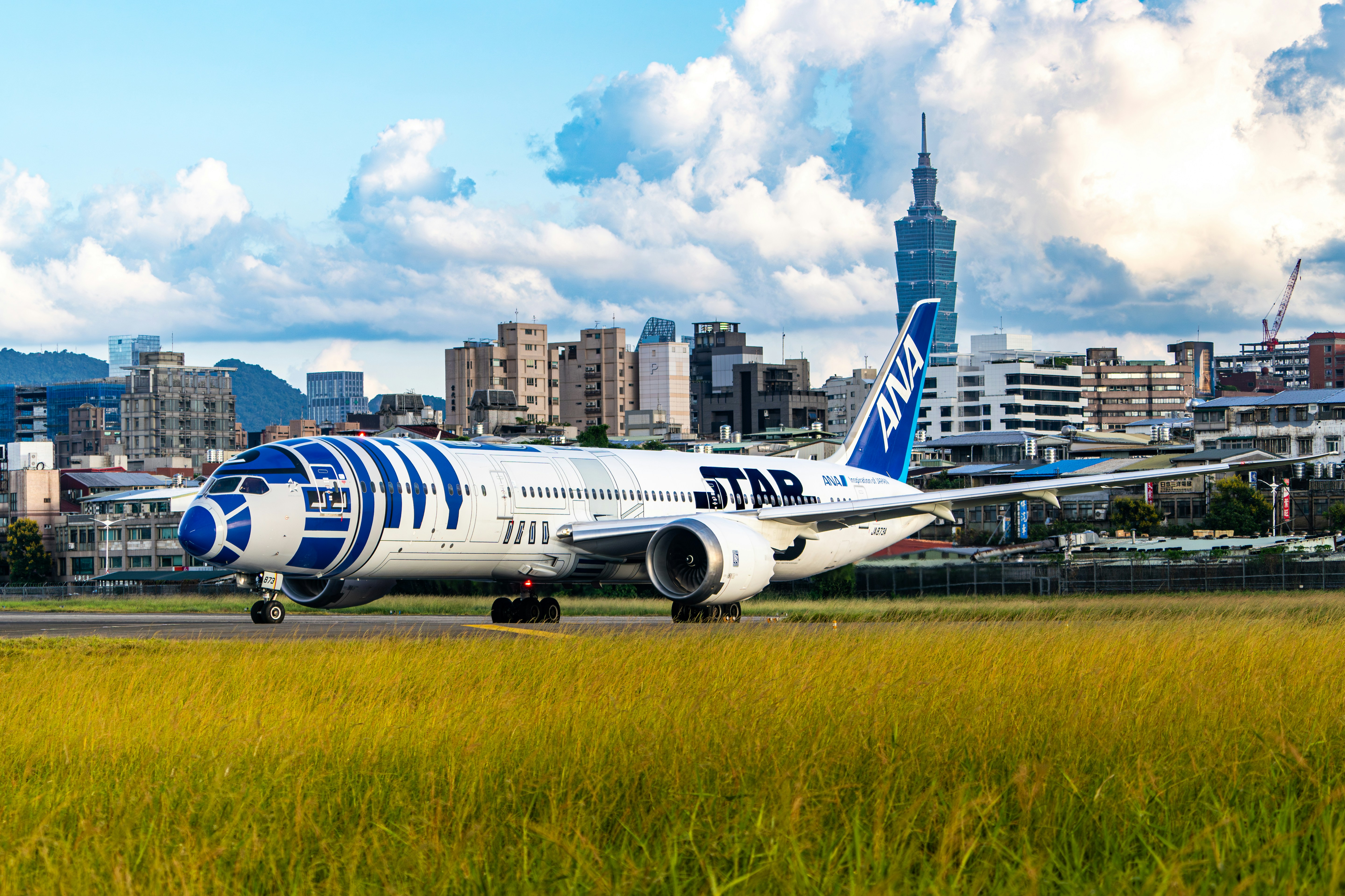 A large jetliner sitting on top of an airport runway, 