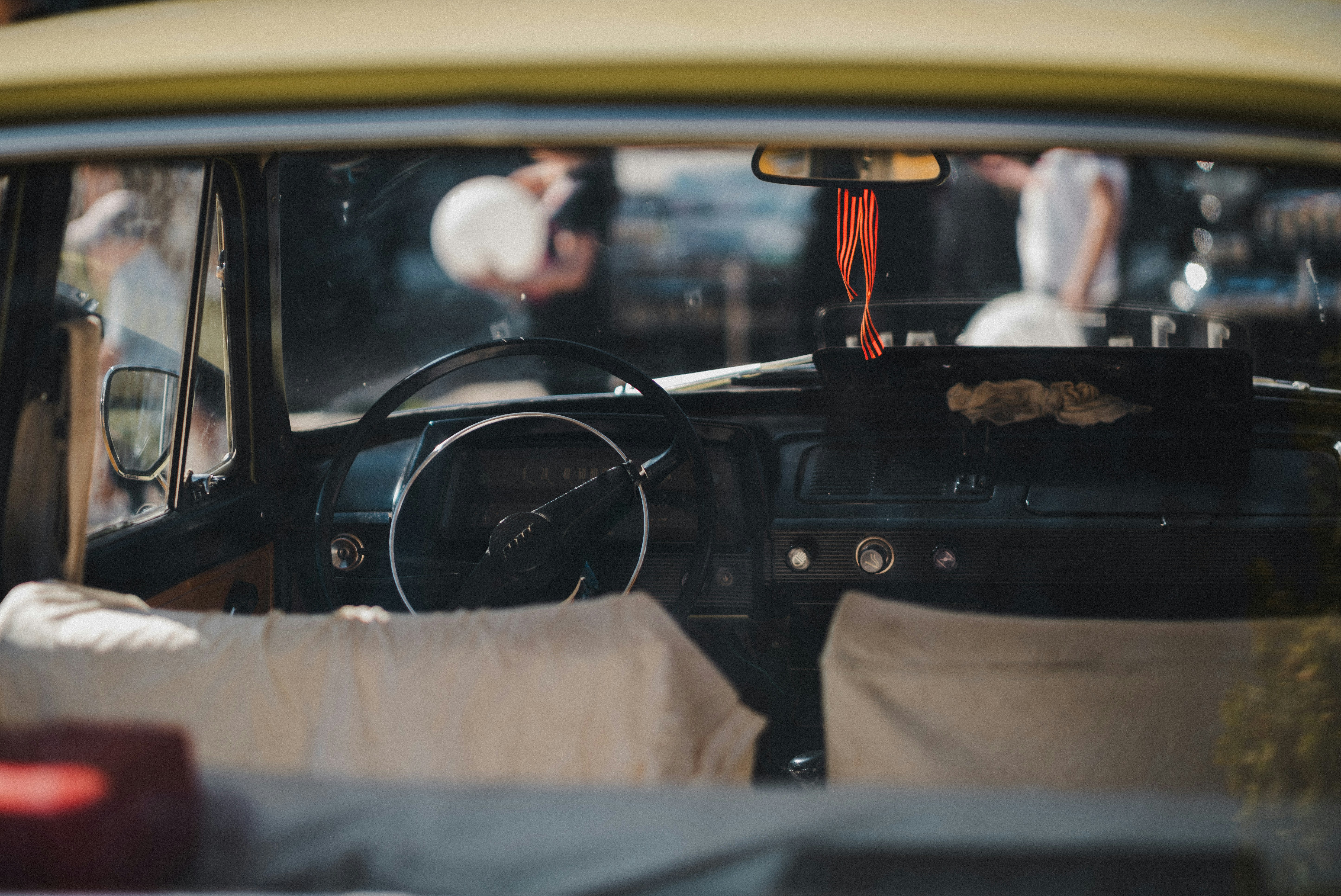 A car with a bunch of pillows in the front seat