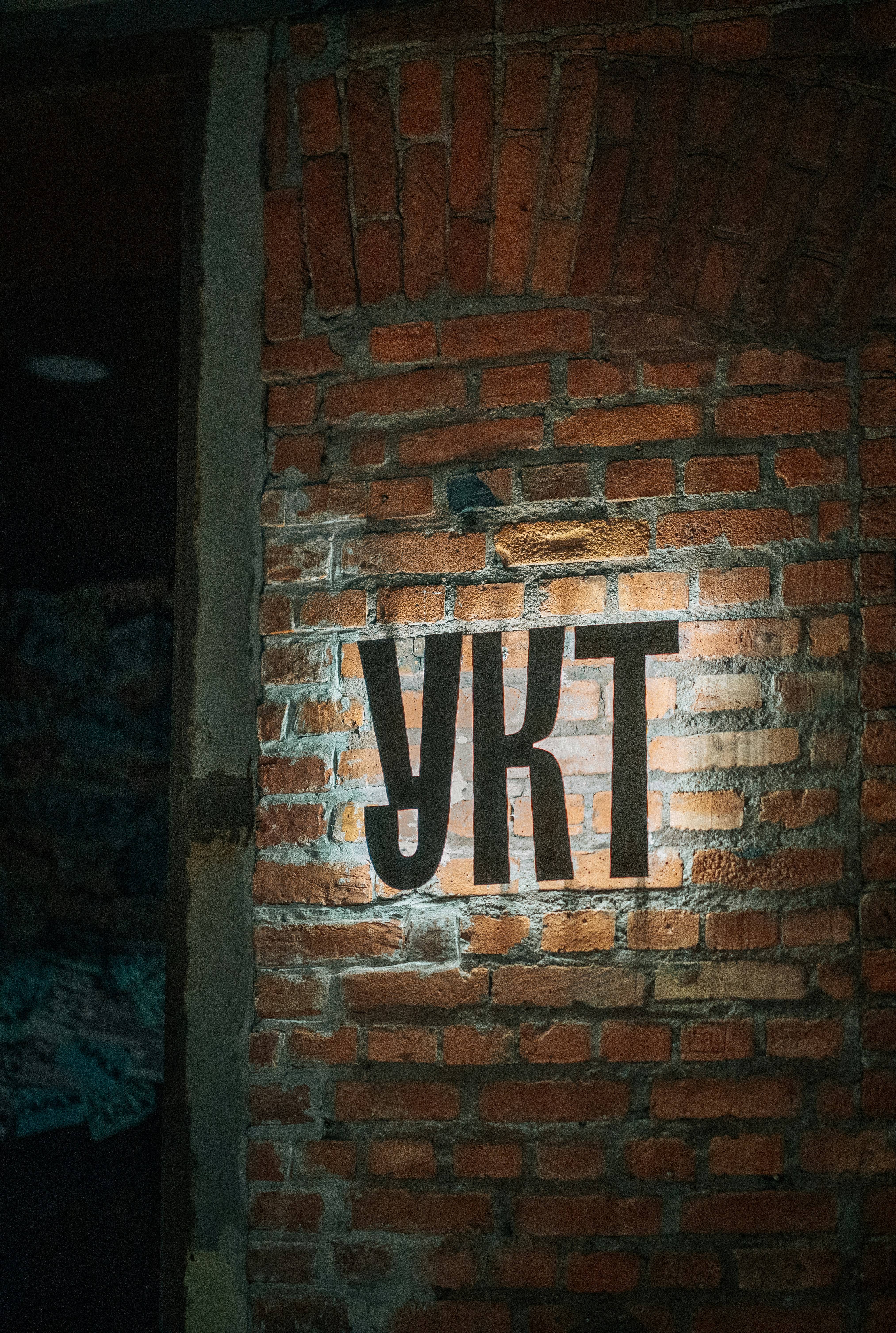 A brick wall with the word ykt painted on it