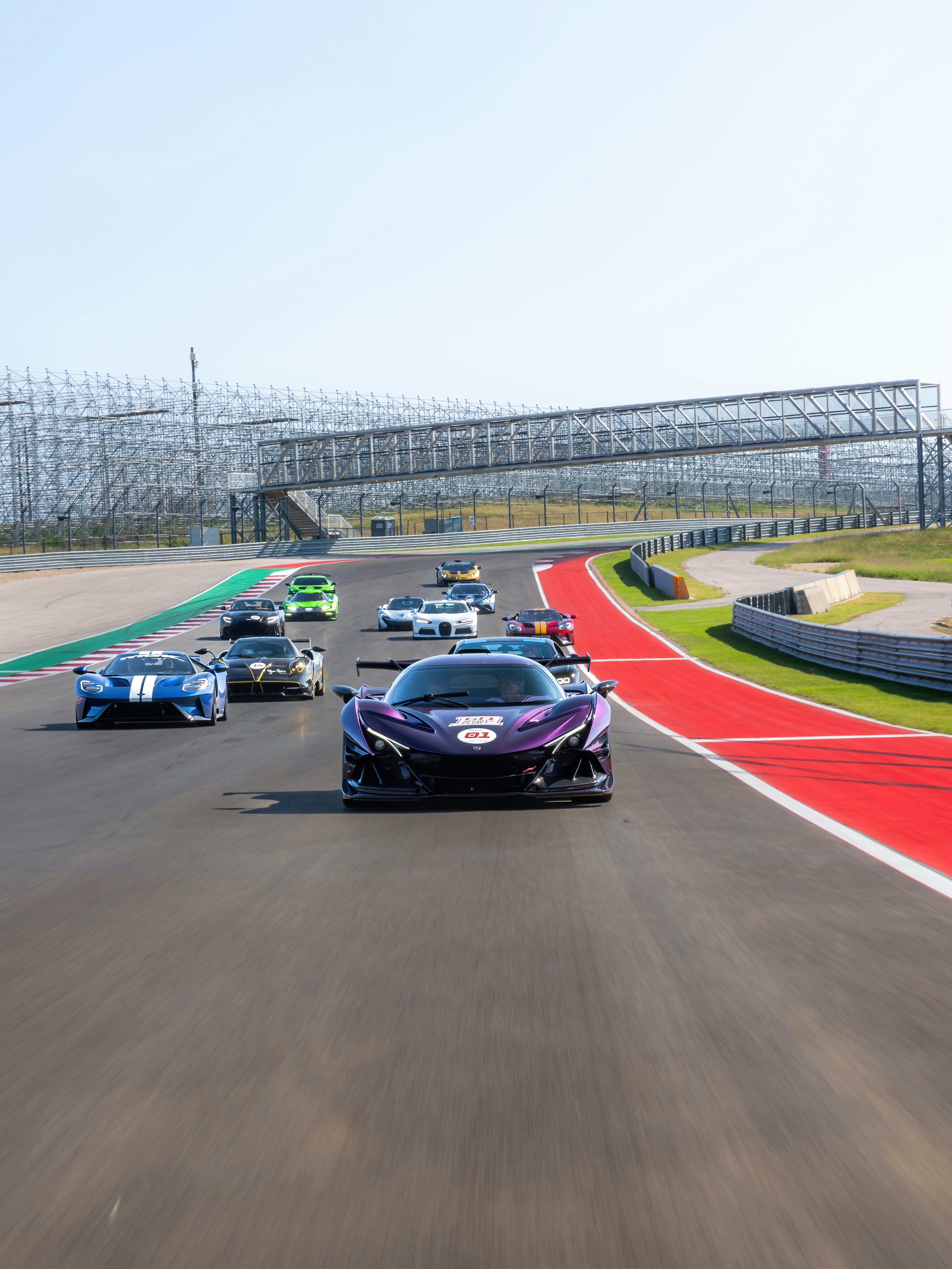 A group of cars driving down a race track photo – Free Zonda Image on ...