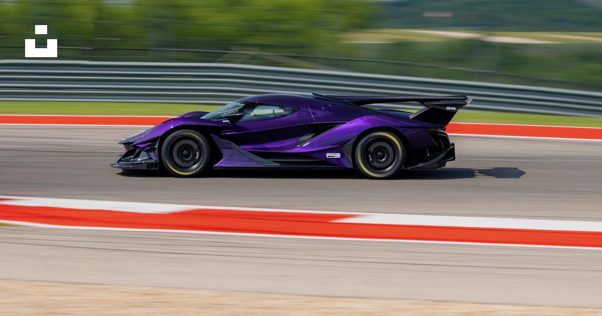 Purple Car Racing A purple sports car driving on a race track photo – Free Blue Image on ...