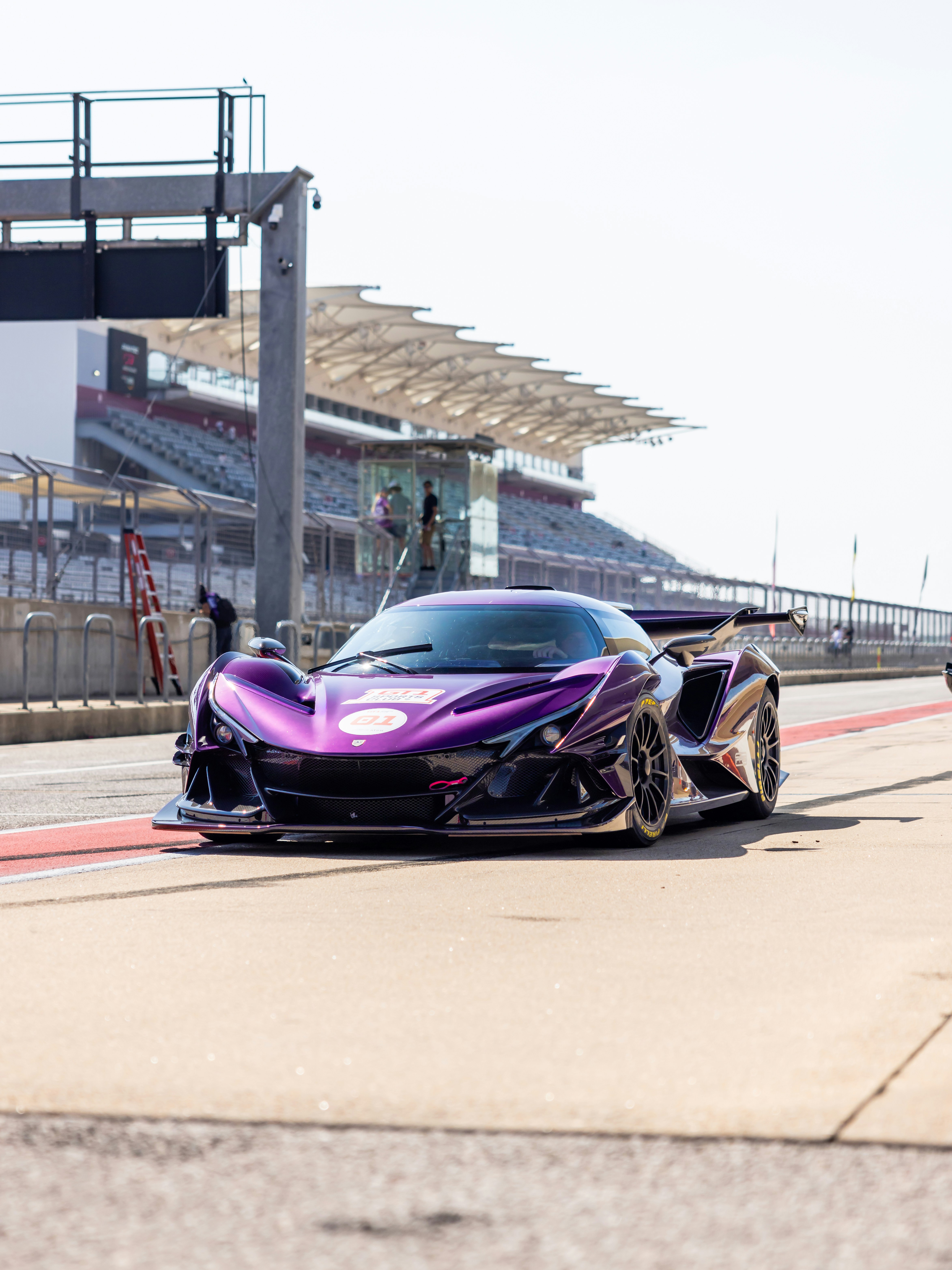 A purple sports car driving down a race track photo – Free Exotic Image ...