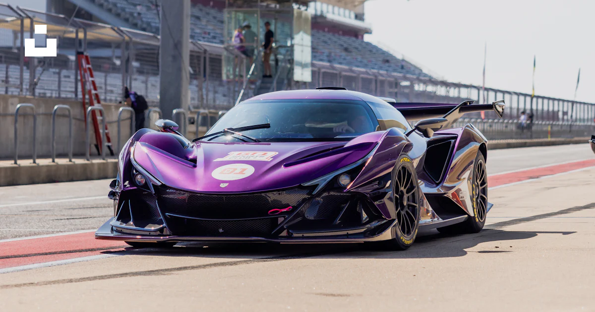Purple Car Racing A purple sports car driving down a race track photo – Free Exotic Image ...