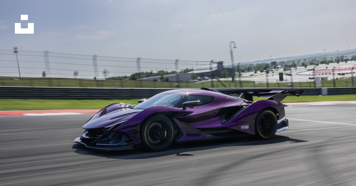 Purple Car Racing A purple sports car driving down a race track photo – Free Zonda Image ...