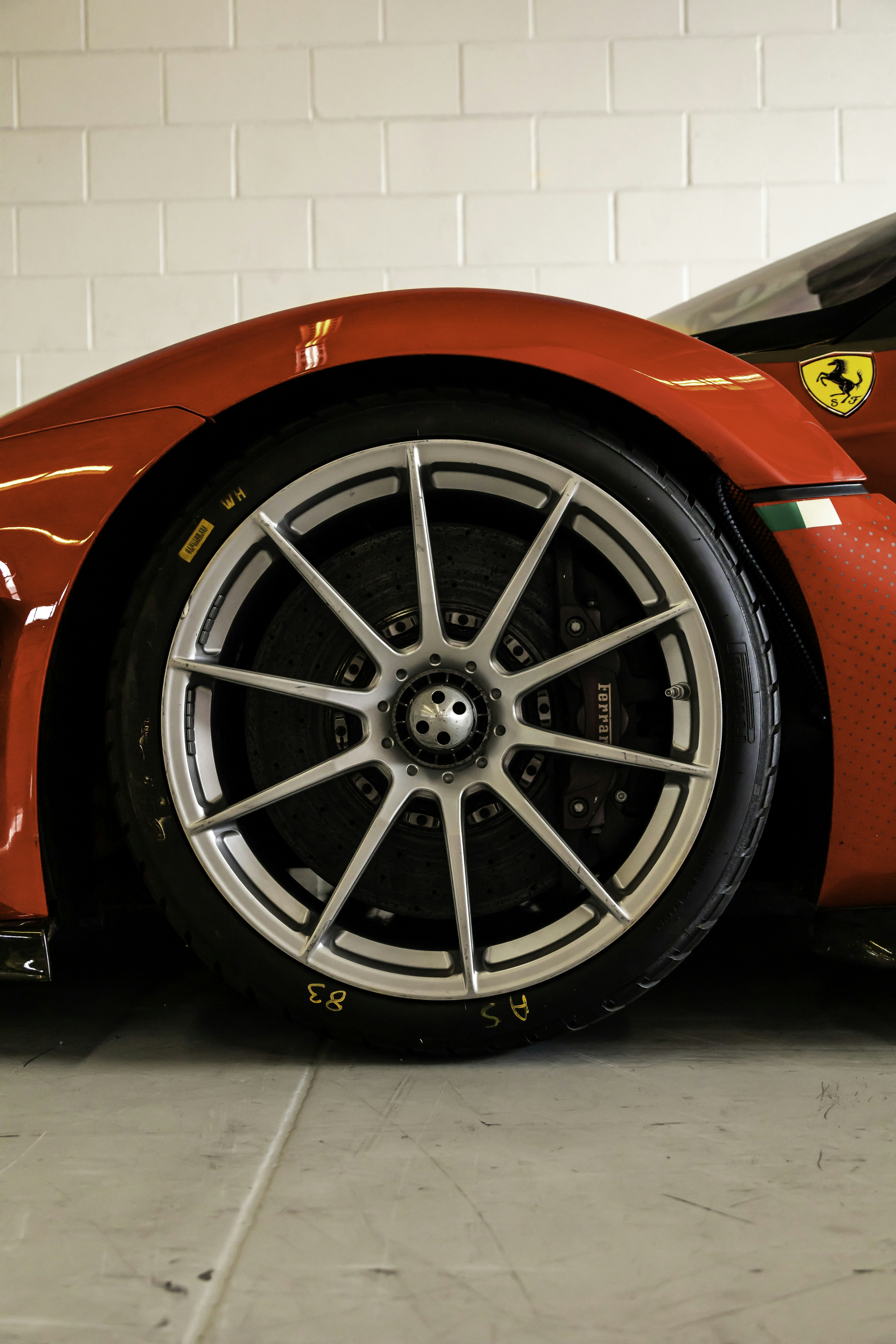 A red sports car parked in a garage