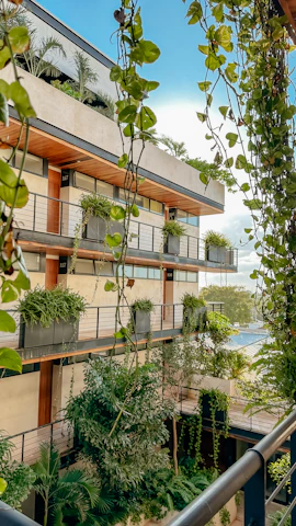 An apartment building with plants growing on the balconies
