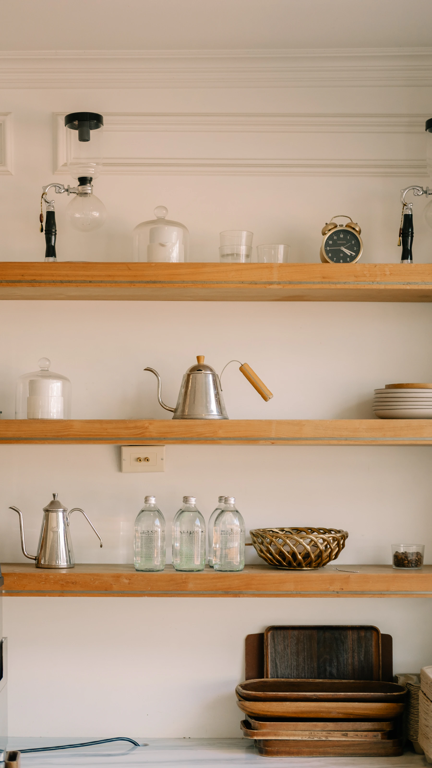 Basement bar cabinetry with lower storage, wood countertops, and open shelf display