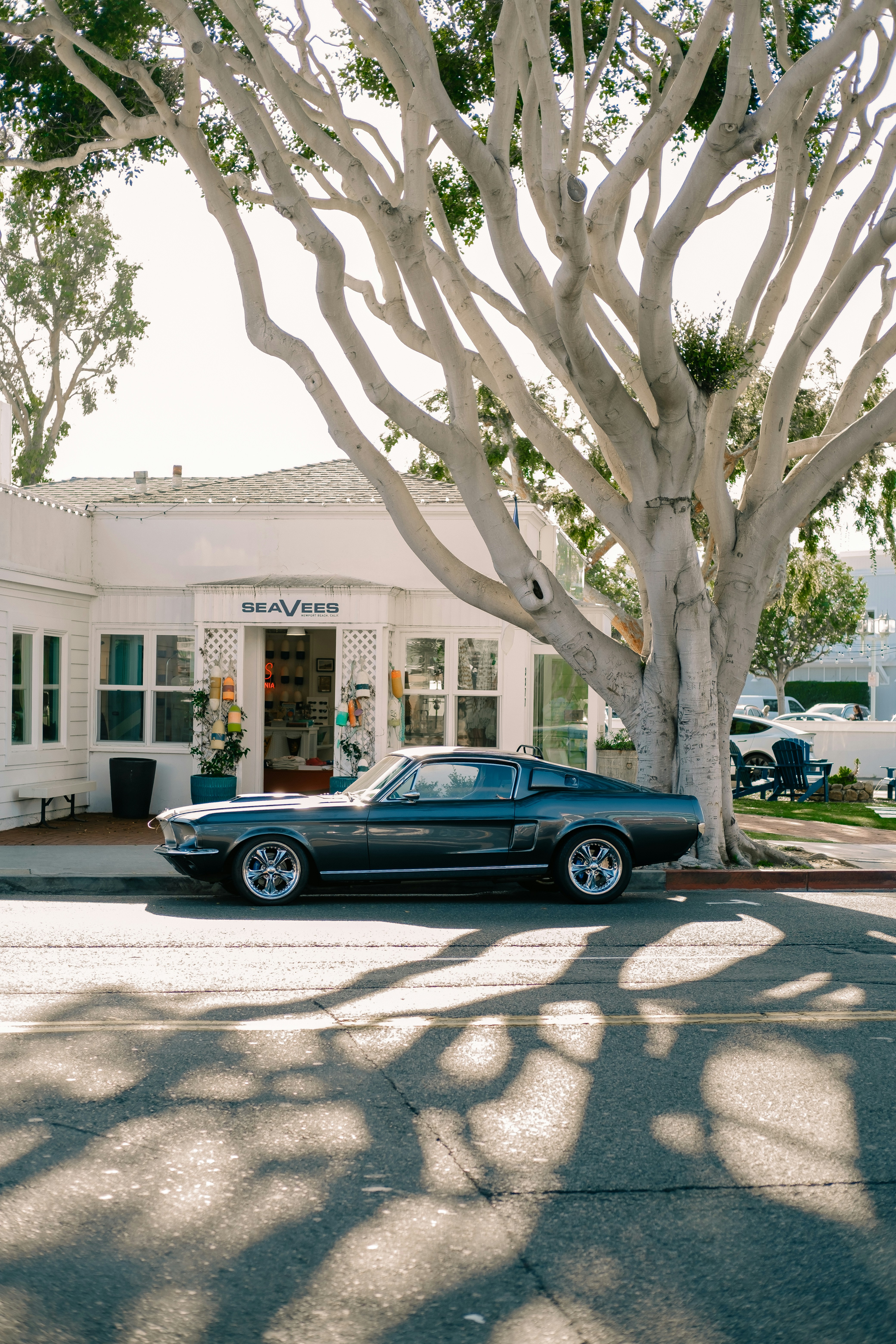 A black car parked in front of a white building