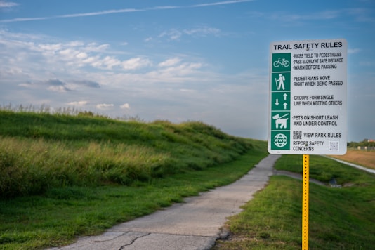 A green and white sign sitting on the side of a road