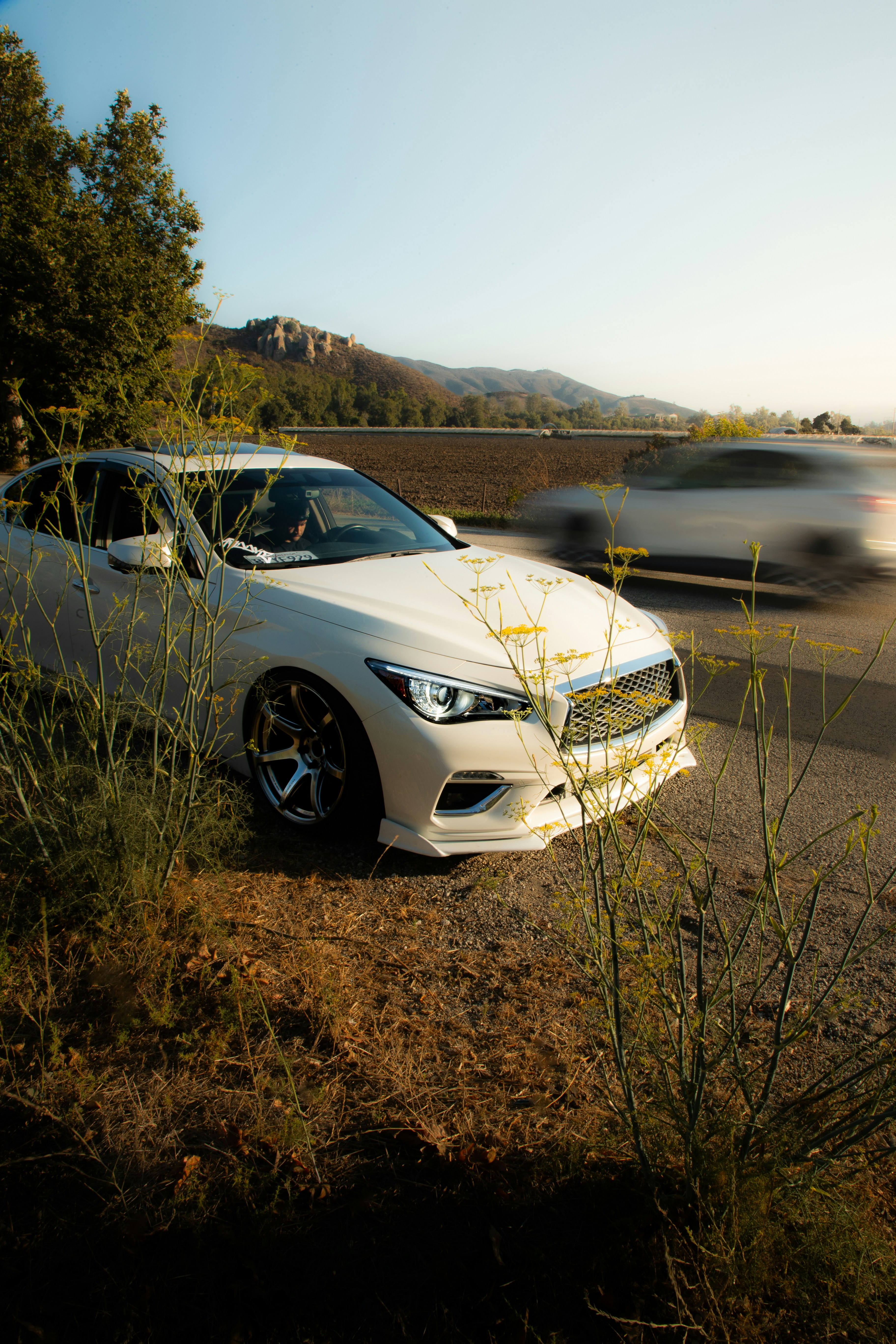 A white car parked on the side of the road