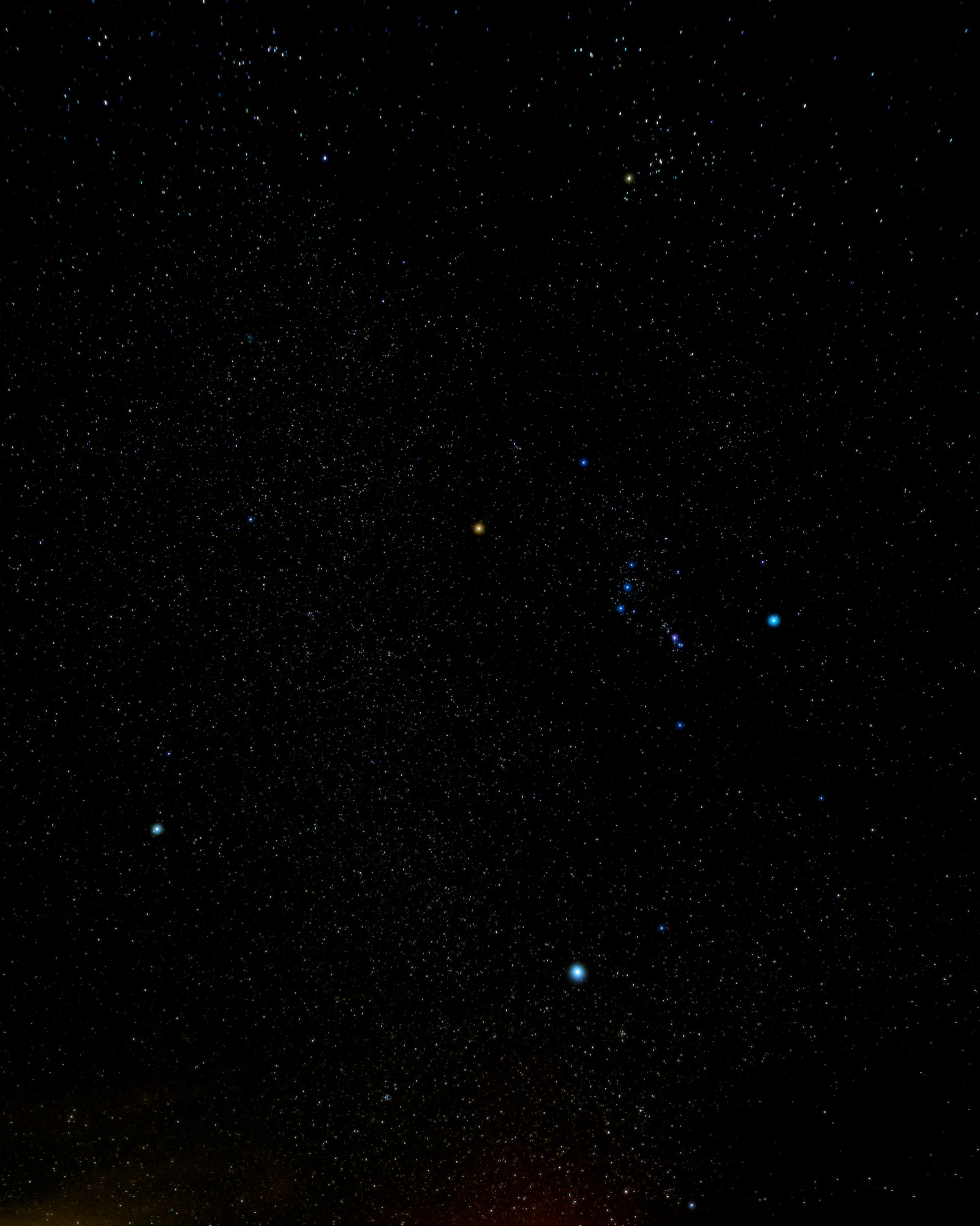A dense field of stars over Death Valley, with Orion's Belt and the Winter Triangle visible