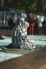 A towel is laying on the ground in front of a group of people