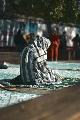 A towel is laying on the ground in front of a group of people