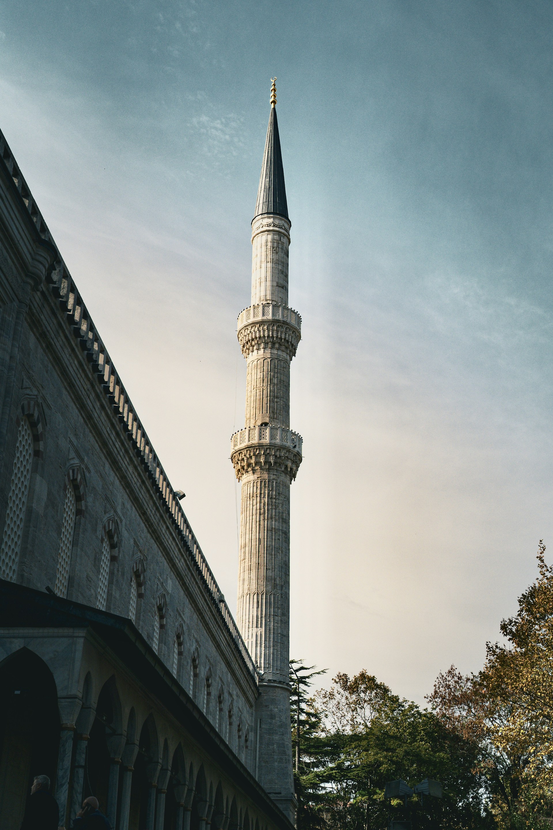 A tall white building with a steeple on top