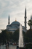A fountain in front of a large building