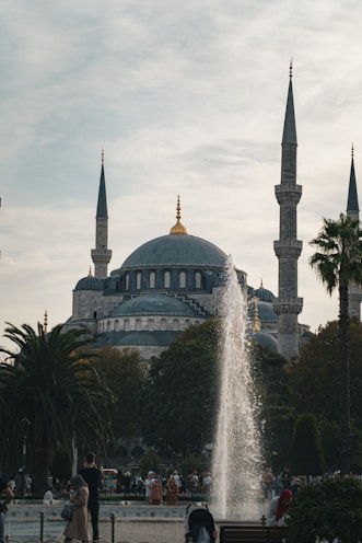 A fountain in front of a large building