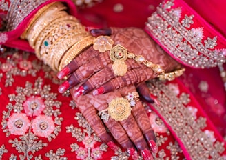 A close up of a woman's hands with jewelry on it