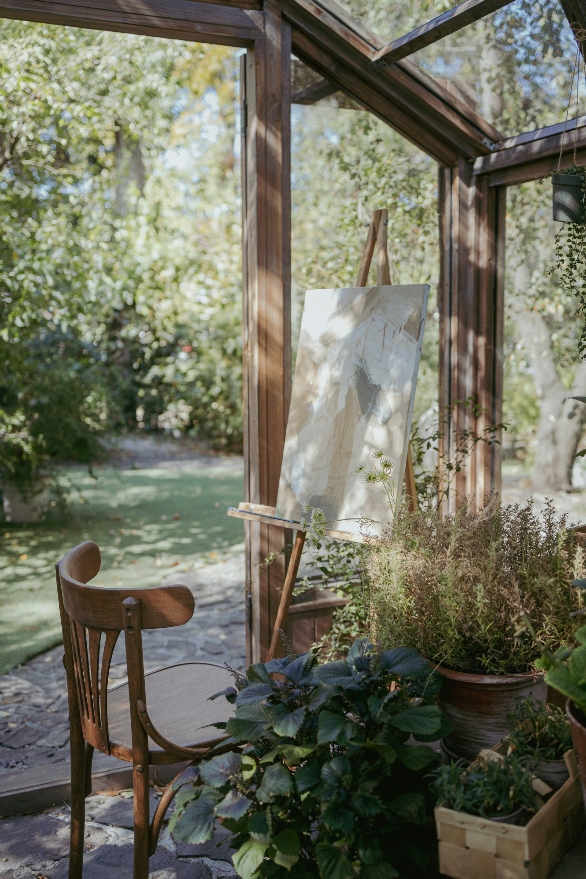 A room filled with lots of plants and a chair
