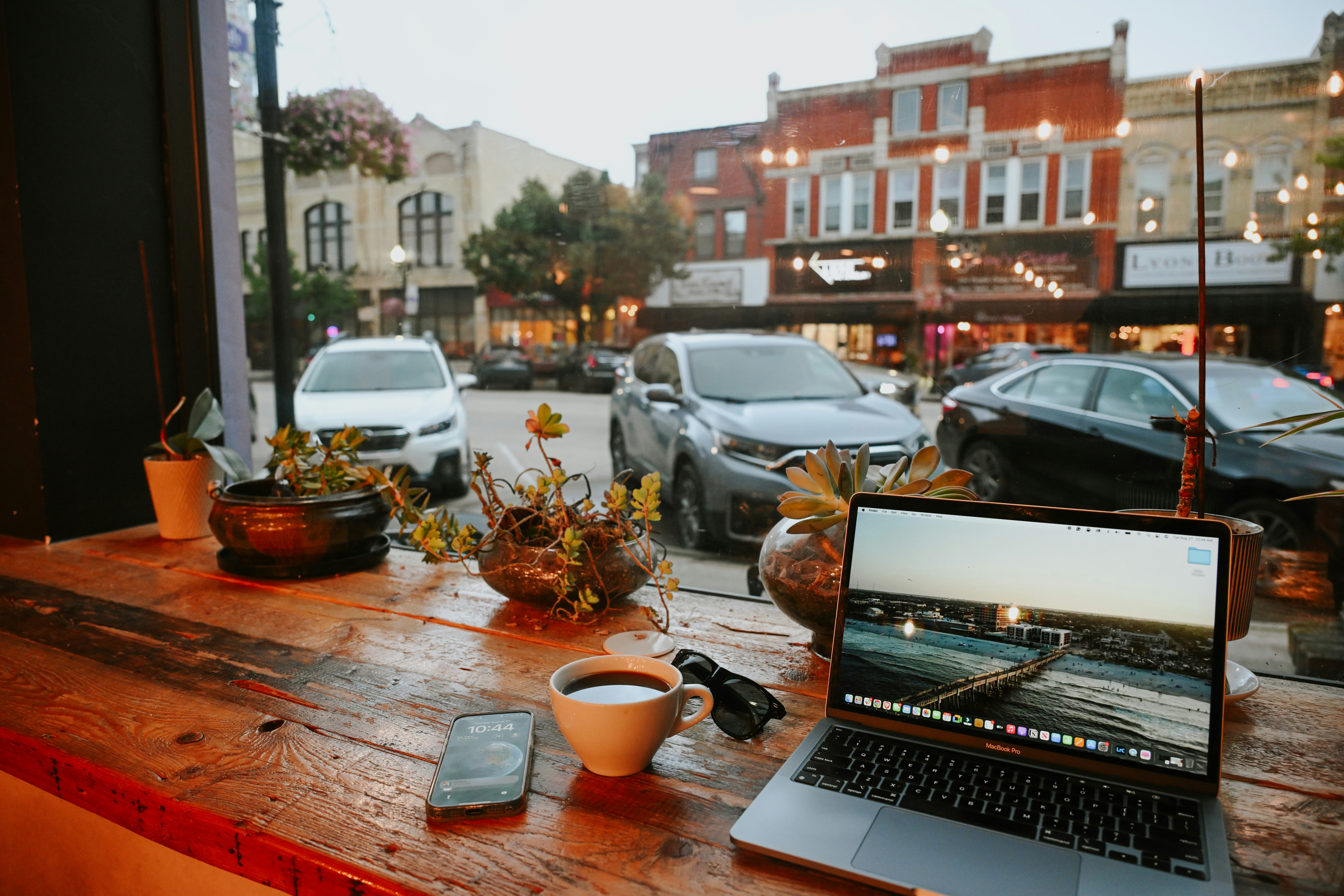 A laptop computer sitting on top of a wooden table
