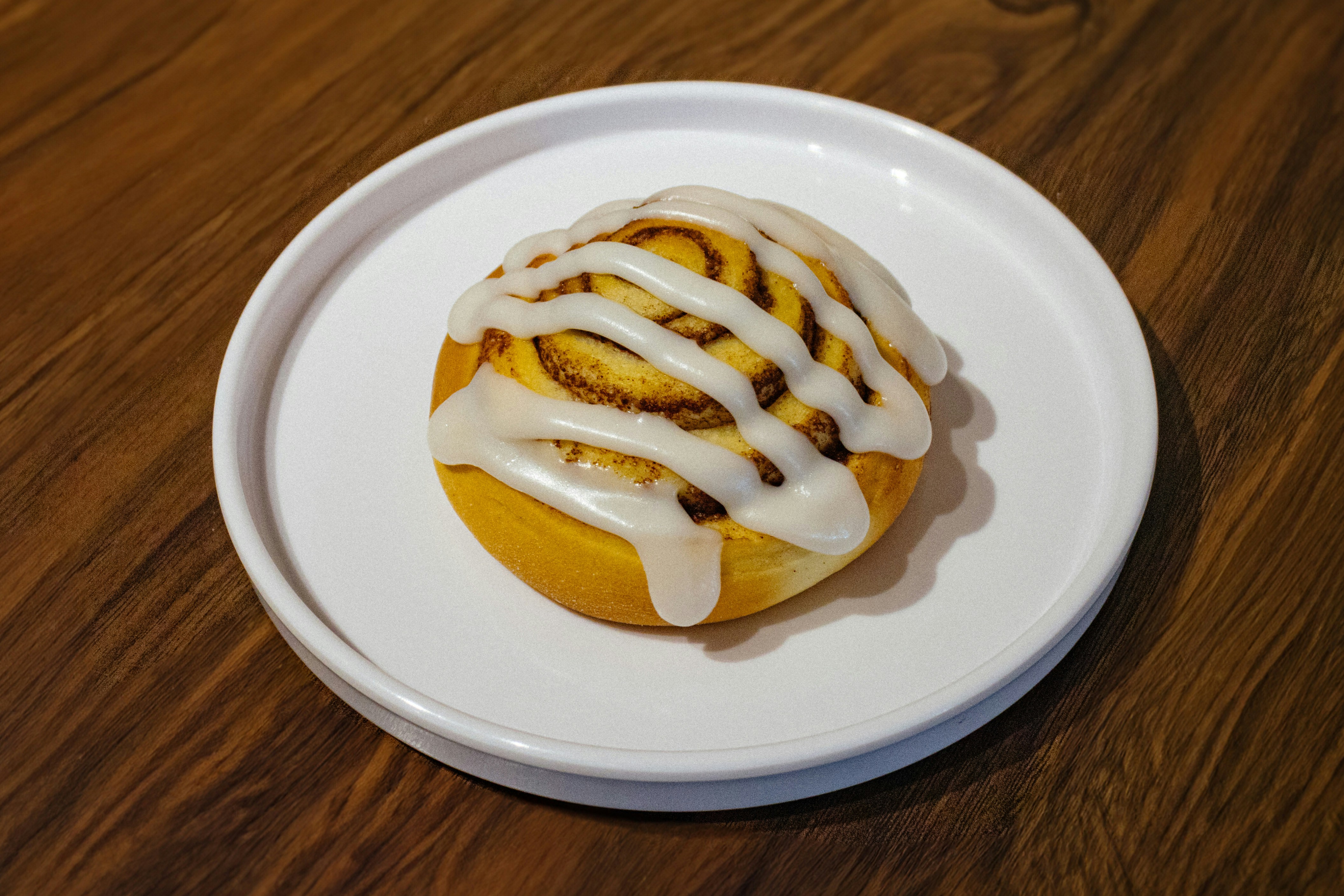Iced cinnamon roll on a plate