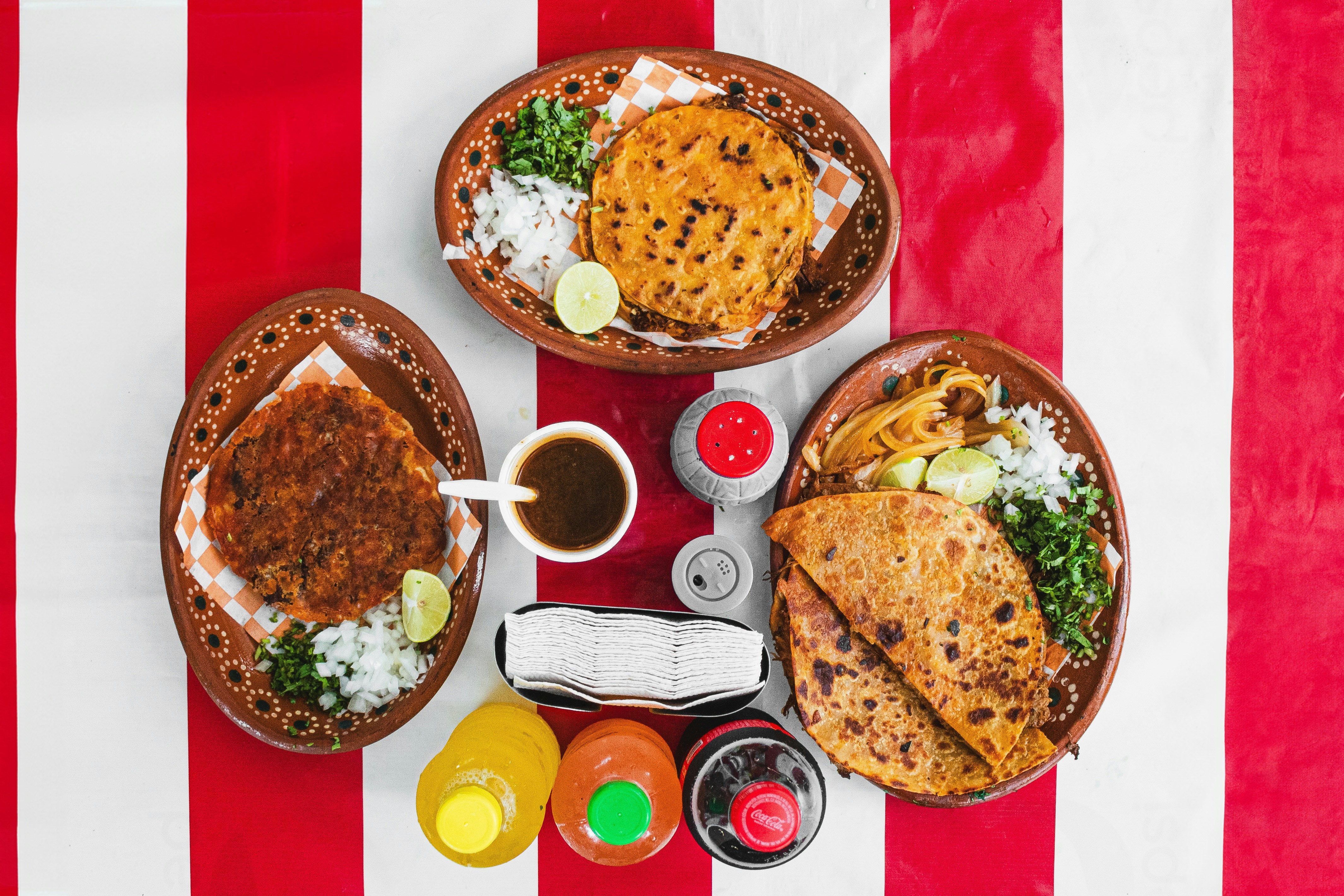 Quesadillas and salsas on a red-striped table