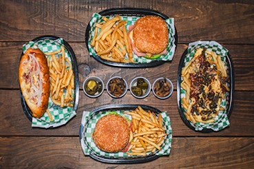 A wooden table topped with plates of food