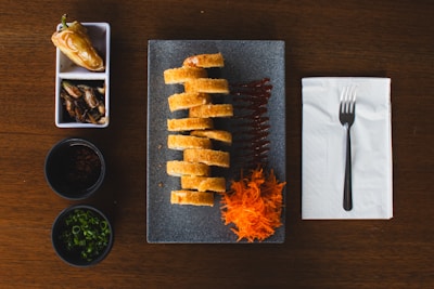 A wooden table topped with a plate of food