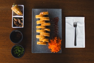 A wooden table topped with a plate of food