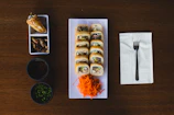 A wooden table topped with plates of food