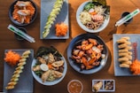A wooden table topped with plates of food