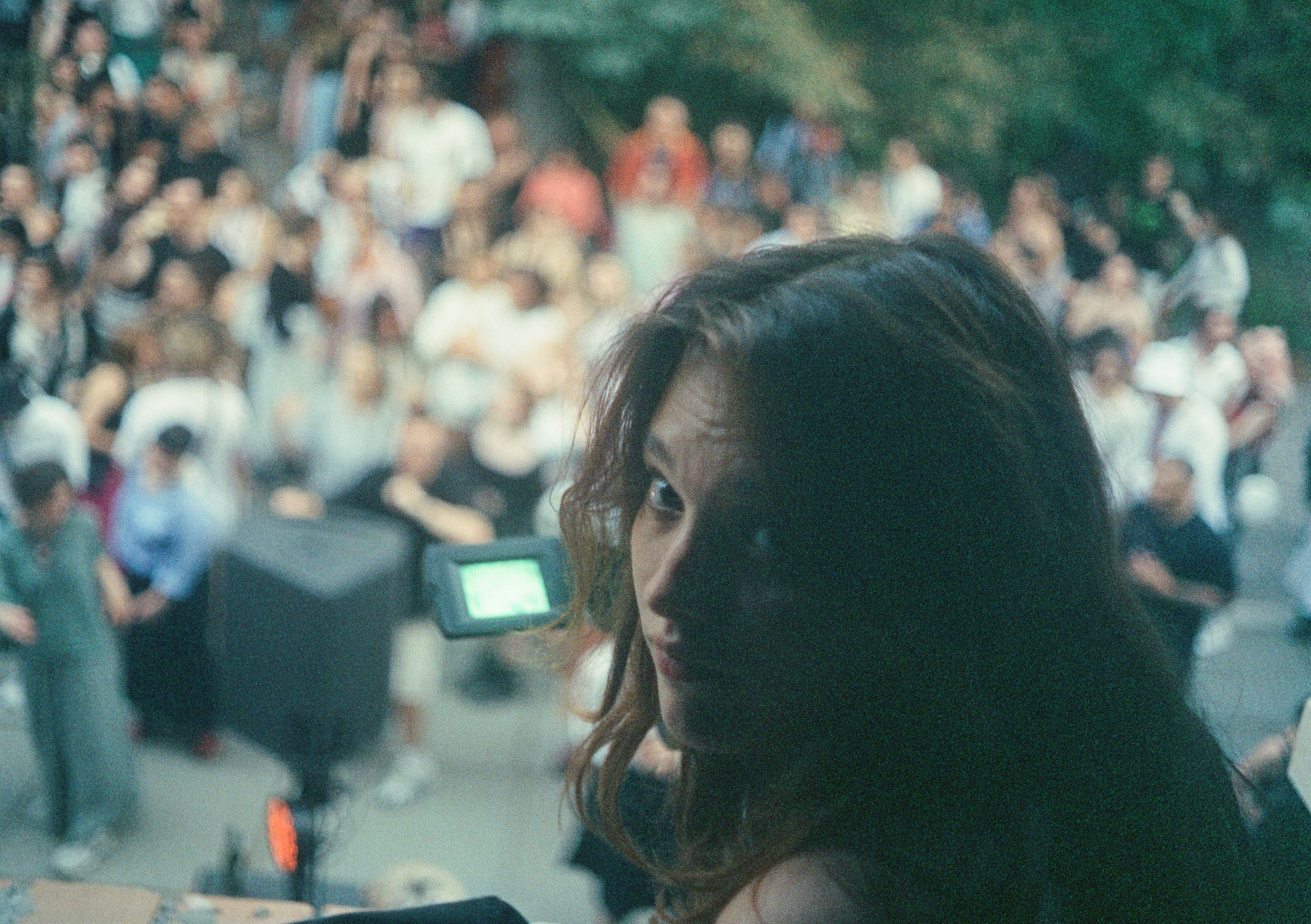 A woman standing in front of a crowd of people