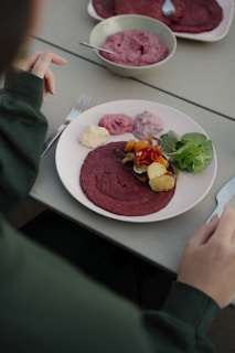 A person sitting at a table with a plate of food